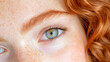 © Lala Farikha - Close-up of a girl's green eye, freckles, and red curly hair