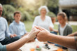 © peopleimages.com - Food, family and holding hands to pray at picnic or outdoor feast for gratitude and holiday celebration. Group, closeup or people together at lunch with faith in garden for thanks, prayer and grace