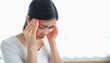 © Ton Photographer4289 - Young woman touching her temples with her hand because of severe headache due to stress or migraine. Health and mental health problem concept.