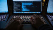 © Tanakorn - Hands typing on laptop keyboard, focused on coding and cybersecurity protocols, illuminated by screen light
