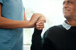 © Kay Abrahams/peopleimages.com - Nurse, senior and man with hand holding for support in retirement home, kindness and trust for assisted living. Closeup, caregiver and elderly person with gesture of comfort and empathy in house.