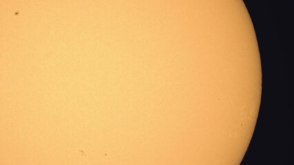 Wall Mural - surface of the sun through telescope with visible sunspots and surface texture and atmosphere turbul