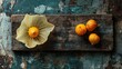 © Photographer - Cape gooseberry (Physalis peruviana) on a rustic wooden board, showcasing its vibrant color and papery husk