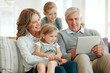 © peopleimages.com - Grandparents, tablet and kids with home movie streaming, internet learning and youth game with generations. Happy, smile and bonding from comedy show watching on website with tech and love for family