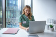 © zinkevych - Female doctor in uniform sitting in hospital office working on laptop