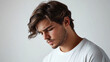 © Tahsin - Portrait of a young man with brown hair and a white t shirt looking down in a studio setting
