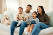 © peopleimages.com - Surprise, family and watching tv at house with streaming movie for love, care and bonding support in living room. Excited, parents and children and film show for wow, entertainment and subscription