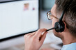 © peopleimages.com - Customer service, call center and man with headset on computer for planning, online help and consulting. Corporate, telemarketing and person with microphone for contact, crm support and communication