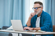 © peopleimages.com - Home, business man and thinking with laptop for reading, research and planning for online session. Freelancer, remote work and mature teacher with tech for digital textbook, educational web and ideas