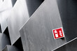 © yaqui_villegas - Fire safety sign integrated in a reflective facade with diagonal metallic lines, symbolizing emergency awareness and clean minimalist urban safety design.