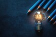 © Aleksandra - Studying Ideas with Glowing Light Bulb and Blue Pencils for Education and Business Learning at Home