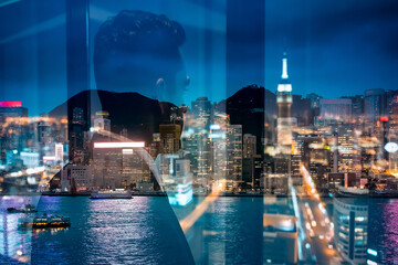 Aufkleber - A double exposure shot merges a silhouette figure with the vibrant, illuminated skyline of Hong Kong at night, creating a layered urban portrait.