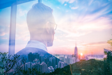 Aufkleber - A double exposure image artfully merges a man in a suit contemplating the vibrant Hong Kong cityscape at sunset, blending urban architecture with the colorful sky.