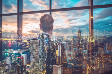 Poster - A man observes the Hong Kong cityscape through a window, creating a double exposure effect. City lights and buildings blend with the interior scene in a modern setting.