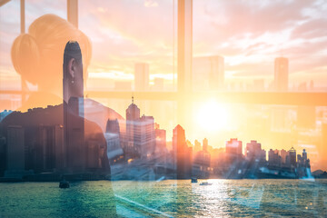 Poster - Hong Kong skyline view with double exposure creates an artistic and layered effect, blending a person's silhouette with the vibrant cityscape and sunset over the water.