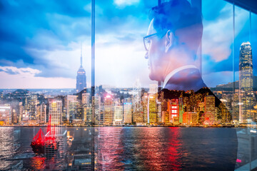 Poster - Hong Kong cityscape at night, blended with man's silhouette in double exposure. City lights reflect on water, creating a dreamy, layered scene.