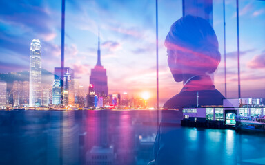 Fototapete - A woman gazes at the vibrant Hong Kong skyline through a window, creating a double exposure effect blending cityscape and interior view at dusk.