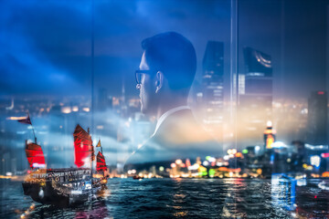 Poster - A double exposure image shows a man in suit looking out over Hong Kong's night cityscape with a traditional junk boat in the harbor.