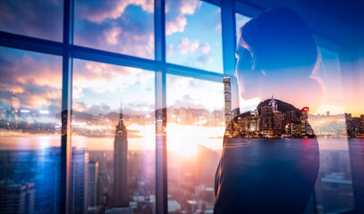 Poster - Contemplative silhouette gazes over a vibrant cityscape, a Hong Kong double exposure blending urban skyline with a person's thoughtful profile against a window view.