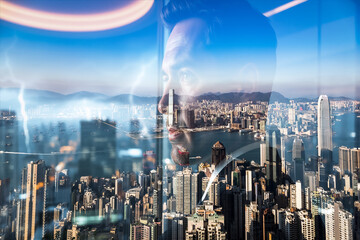 Poster - Hong Kong cityscape with a double exposure effect showing a person's face overlaying the urban skyline. Modern buildings and bright daytime lighting are visible.