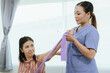 © Witoon - An elderly woman is assisted by a physical therapist to rehabilitate and stretch her arm during a treatment that focuses on physical rehabilitation, mobility and pain relief.