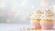 © dreamer - Two elegantly frosted cupcakes adorned with golden sprinkles, set against a soft, blurred background, creating a delightful and festive atmosphere.