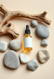 Amber glass essential oil bottle, smooth gray river stones, driftwood branch, green leafy sprigs, natural linen backdrop, spa wellness composition