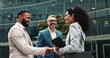 © peopleimages.com - City, business people and smile with handshake for welcome, greeting and agreement for realtors. Urban, clients and real estate agent with shaking hands for introduction, deal success and partnership
