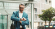 © CC/peopleimages.com - Businessman, worry or check watch in city for time management, agenda or late for meeting. Mature person, stress or wristwatch in town for commute schedule, interview appointment or missed deadline
