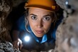 © Milos - A brave woman explores a cave, illuminating her surroundings with a flashlight, showcasing the spirit of adventure and discovery in nature's depths.