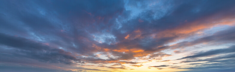 Wall Mural - beautiful blue sky with a few clouds and a pinkish orange sun