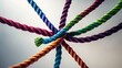 © VRVisionary - Business teams success and unity teamwork metaphor as a representation of forming a partnership of diversity through interconnected ropes in collaboration.