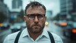 ©  Shomixer - A rugged man stands in the rain, his serious expression reflecting resilience in the face of challenges, against a blurred urban background filled with city lights.