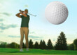 © New Africa - Man playing golf on green course, focus on flying ball. Low angle view