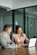© insta_photos - Professional leaders having corporate discussion planning project. Two executive business managers working on laptop computer discussing financial accounting project at office meeting. Vertical photo.