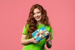 © kohanova1991 - Happy ginger-haired woman gift box, pink background. Lady smiling, interested