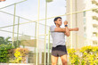© CandyRetriever  - Healthy wellness Asian man sport training fitness workout exercise at stadium gym. Young male in sportswear warm up breathing exercise stretching body before playing tennis at outdoor court.