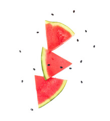 Wall Mural - flying pieces of fresh watermelon and seeds on white background