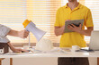 © Pixel-Shot - Constructors with megaphone working at table in office
