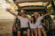 © sorapop - Asian family sitting back car to beach at sunset feeling funny in holidays and relaxation together. Dad, mom and daughter happy weekend travel enjoy at beach. summer vacation travel camping road trip