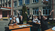 © Довидович Михаил - Cheerful students throwing books in the air to celebrate the end of the school year outside the school building