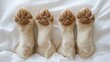 © Aleksandra - Four adorable puppy paws on white sheets