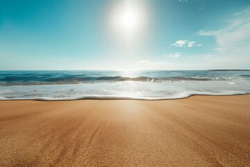 gentle waves lap against the shore under a bright sun on a clear day at a tranquil beach