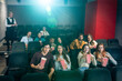 © unai - People watching movie and eating popcorn in cinema