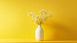 © HISTOCK - White vase with flowers standing on yellow table against yellow wall