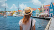© Nova Zigres - Holidays in Curacao, Caribbean Sea. Back view of tourist woman visiting Willemstad, Curaçao, Lesser Antilles in Caribbean Sea.