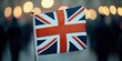 © Ingvar Shelly - historical celebration, a detailed close-up of a waving union jack flag with blurred background of people celebrating ve day