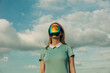 © ADDICTIVE STOCK - Woman with futuristic visor under a cloudy sky