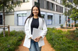 © ADDICTIVE STOCK - Confident Businesswoman Walking Outdoors with Laptop