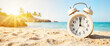 © Anastasiya - Bright alarm clock on sandy beach during sunny afternoon, vacation countdown